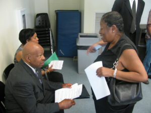 Rep. Elijah Cummings with constituent at foreclosure prevention workshop (2012)