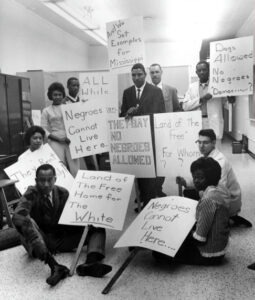 Members of the NAACP’s Housing Committee create protest signs in the Detroit Branch office (1962)