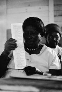 Woman Looking at a Sample Voting Ballot